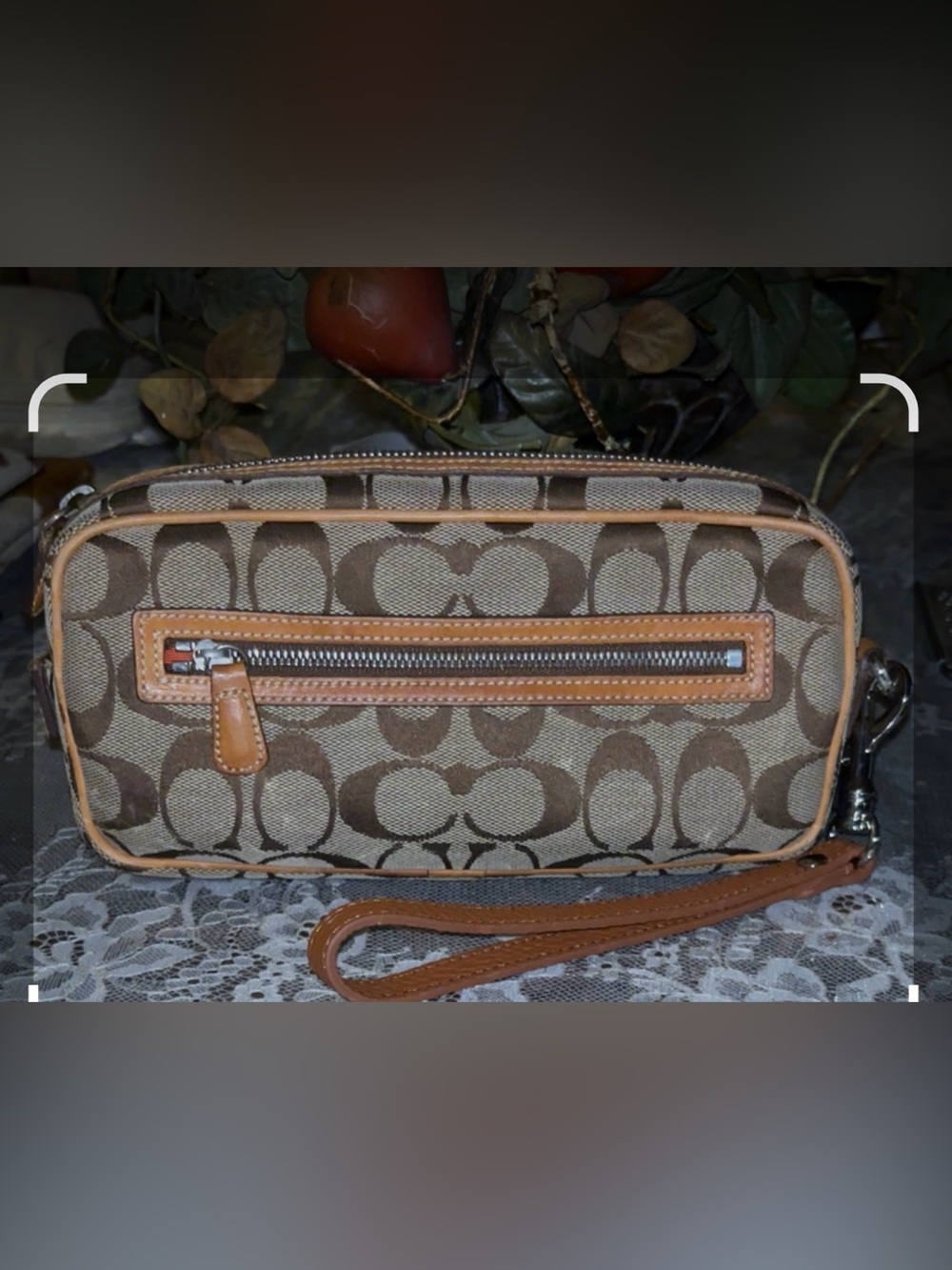 Coach vintage wristlet  bag is crafted from signature canvas tan leather trim
